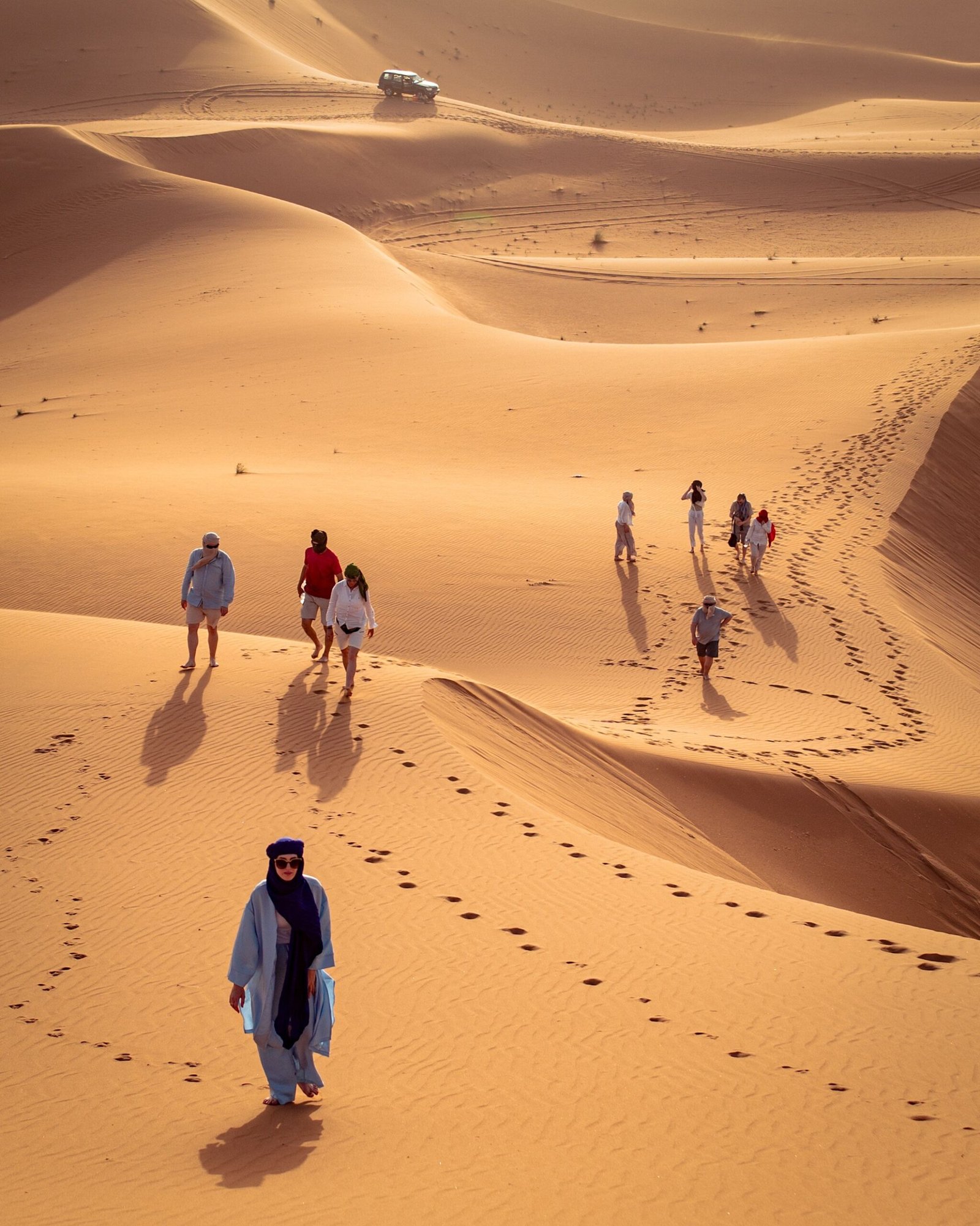 Traveller walking along a dune ridge in Merzouga
